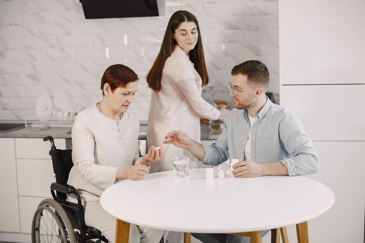 Caregiver sharing a table with an older resident
